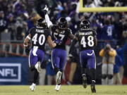 Baltimore Ravens inside linebacker C.J. Mosley, center, celebrates his interception with teammates Kenny Young, left, and Patrick Onwuasor in the second half of an NFL football game against the Cleveland Browns, Sunday, Dec. 30, 2018, in Baltimore. Baltimore Ravens won 26-24.