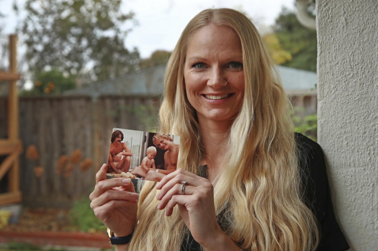 Diana Sauer holds a family photograph of her father, Warren Deboer, holding her as a baby, and his best friend Russell Anderson, left, in Concord, Calif. In the aftermath of Northern California’s catastrophic wildfire, social media sites filled with posts from people trying to find loved ones in and near the town of Paradise. A group of women scattered across the U.S. knew they could help. The women volunteer as “search angels, “ those who help adoptees find their biological parents. So far, they have tracked down nearly 250 people and linked them with friends and family who were looking for them becoming known as the Angels of Paradise.