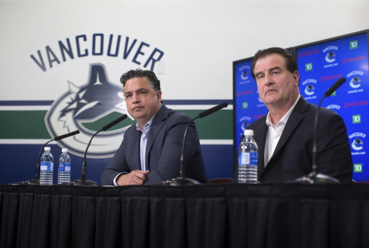 Vancouver Canucks head coach Travis Green, left, and general manager Jim Benning and other officials are envisioning a time in a few years when fans of Seattle’s new NHL franchise will make the trek north into downtown Vancouver to watch their team play the Canucks as part of a healthy rivalry.