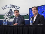 Vancouver Canucks head coach Travis Green, left, and general manager Jim Benning and other officials are envisioning a time in a few years when fans of Seattle’s new NHL franchise will make the trek north into downtown Vancouver to watch their team play the Canucks as part of a healthy rivalry.