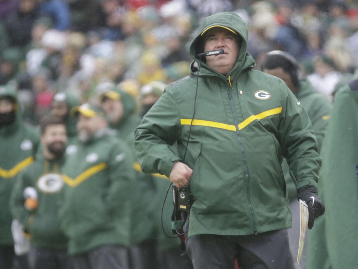 Green Bay Packers’ Head Coach Mike McCarthy watches a replay on the scoreboard during the first half of an NFL football game against the Arizona Cardinals Sunday, Dec. 2, 2018, in Green Bay, Wis.