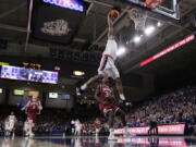 Gonzaga forward Rui Hachimura, top, dunks in front of Denver forward Abiola Akintola during the first half of an NCAA college basketball game in Spokane, Wash., Friday, Dec. 21, 2018.