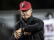 Neil Lomax, Fort Vancouver head coach, checks his watch while running warm ups before a game in the Kiggins Bowl on Friday night, Oct.