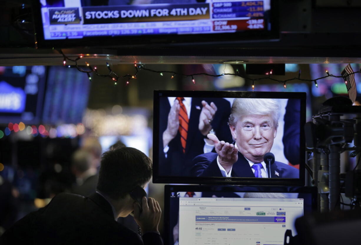 A picture of President Donald Trump is displayed on a computer Monday on the floor of the New York Stock Exchange in New York.