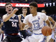 North Carolina’s Cameron Johnson (13) dribbles the ball while Gonzaga’s Corey Kispert (24) defends during the first half of an NCAA college basketball game in Chapel Hill, N.C., Saturday, Dec. 15, 2018.