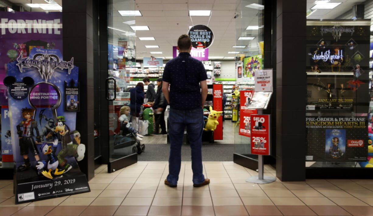 A 27-year-old self-described tech addict poses for a portrait Dec. 9 in front of a video game store at a mall in Everett. He asked to remain anonymous because he works in the tech industry and fears that speaking out about the negatives of excessive tech use could hurt his career.