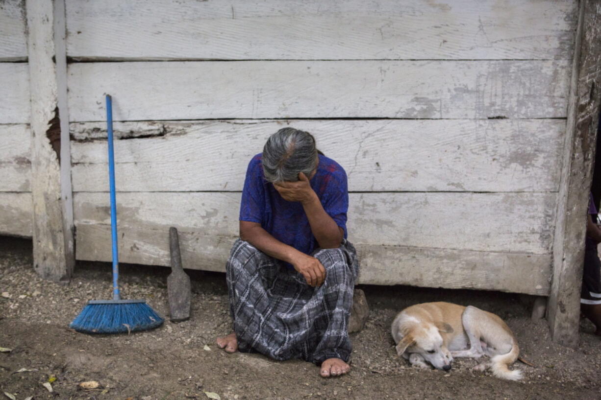 Elvira Choc, 59, Jakelin Amei Rosmery Caal’s grandmother, rests her head on her hand Saturday in front of her house in Raxruha, Guatemala. The 7-year old girl died in a Texas hospital, two days after being taken into custody by border patrol agents in a remote stretch of New Mexico desert.