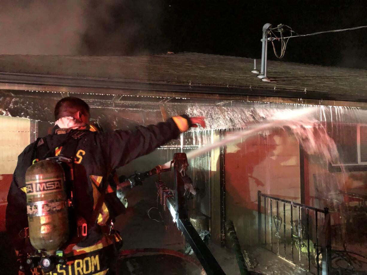 The Camas-Washougal Fire Department working on a fire in an attached garage at a home on the 4000 block of C Street, Washougal. The occupants were home, but evacuated without injuries.