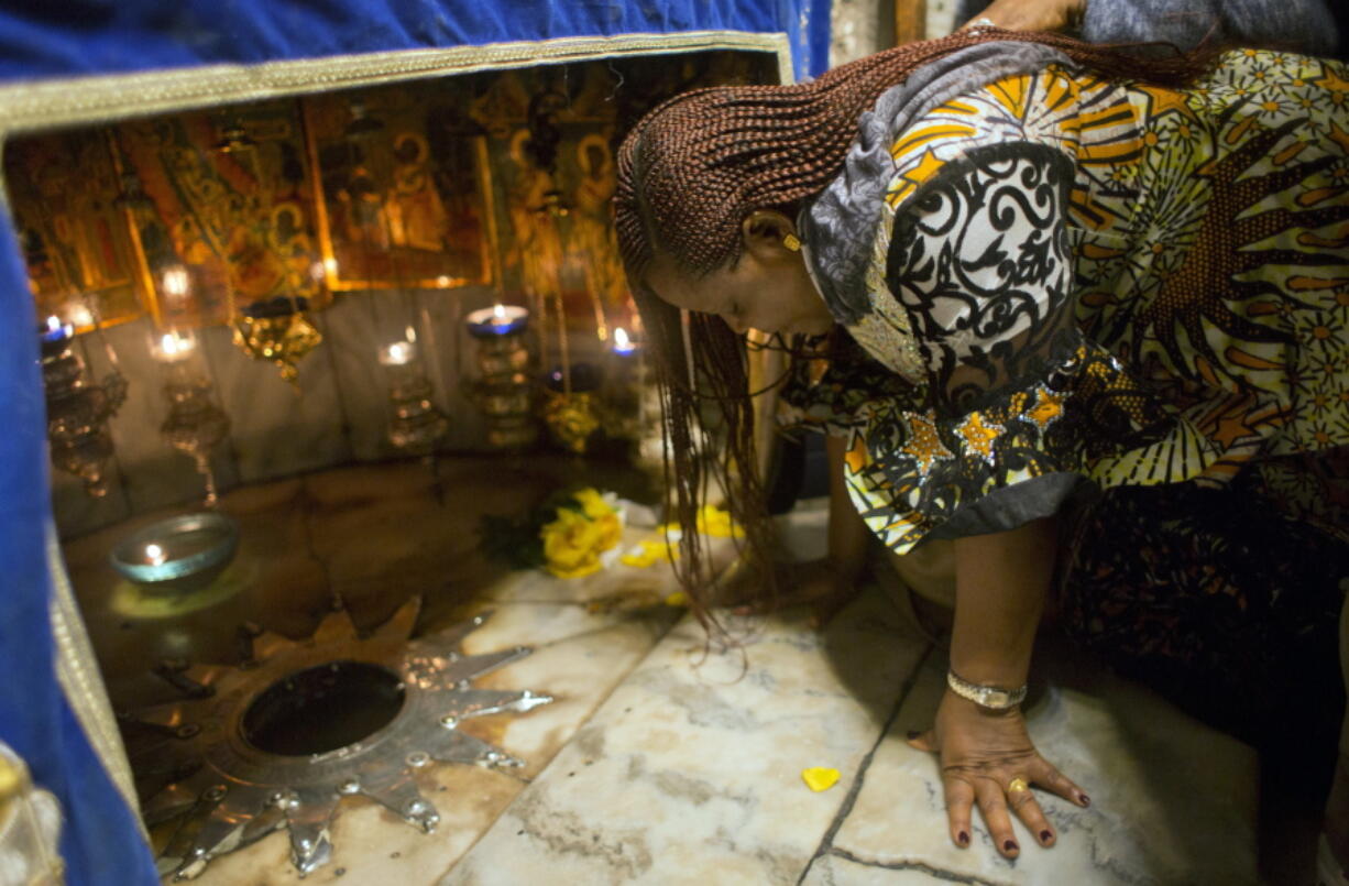 A Christian worshipper prays at the Grotto, under the Church of the Nativity, traditionally recognized by Christians to be the birthplace of Jesus Christ, in the West Bank city of Bethlehem, Sunday, Dec. 23, 2018. Christians around the world will celebrate Christmas on Monday.