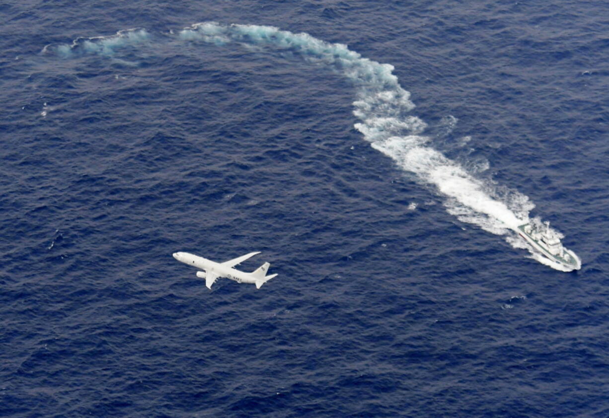 Japan’s Coast Guard ship, top, and U.S. military plane are seen at sea off Kochi, southwestern Japan, during a search and rescue operation for missing crew members of a U.S. Marine refueling plane and fighter jet. The U.S. Marine Corps have declared that five crewmembers dead after their aircraft crashed last week off Japan’s southern coast and that their search has ended.