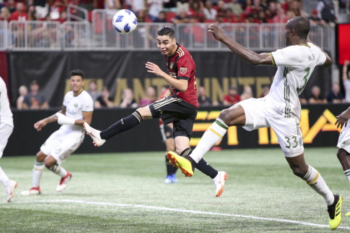 Atlanta United midfielder Miguel Almiron (10) has a shot defended by Portland Timbers defender Larrys Mabiala (33) in the second half of an MLS match on June 24, 2018 at Atlanta. Before an expected crowd of more than 70,000, Atlanta United will host the Portland Timbers in the MLS Cup championship game Saturday, Dec. 8, 2018.