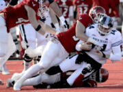 Eastern Washington Eagles Mitchell Johnson (94) and Jonah Jordan (91) sack Maine’s quarterback Chris Ferguson during the first half of a college football game on Saturday, Dec.15, 2018, in Cheney, Wash.