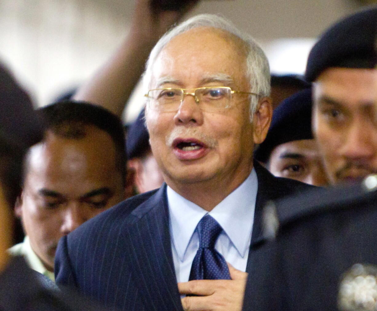 Former Malaysian Prime Minister Najib Razak walks out of courtroom after a court hearing at Kuala Lumpur High Court in Kuala Lumpur, Malaysia. Malaysia says it has filed criminal charges against Goldman Sachs and two of its employees in connection with a multibillion-dollar scandal involving state investment fund 1MDB. Najib launched 1MDB in 2009 to promote economic development but it racked up billions of dollars in debts that have led to investigations in the U.S. and several other countries.