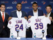 New York Mets’ Robinson Cano, second left, and Edwin Díaz, third left, pose with their new jerseys as they are introduced at a news conference at CitiField, in New York, Tuesday, Dec. 4, 2018. The Mets acquired eight-time All-Star second baseman Robinson Cano and major league saves leader Edwin Diaz from the Seattle Mariners in a seven-player trade Monday. They are joined by New York Mets General Manger Brodie Van Wagenen, left, and team COO Jeff Wilpon.