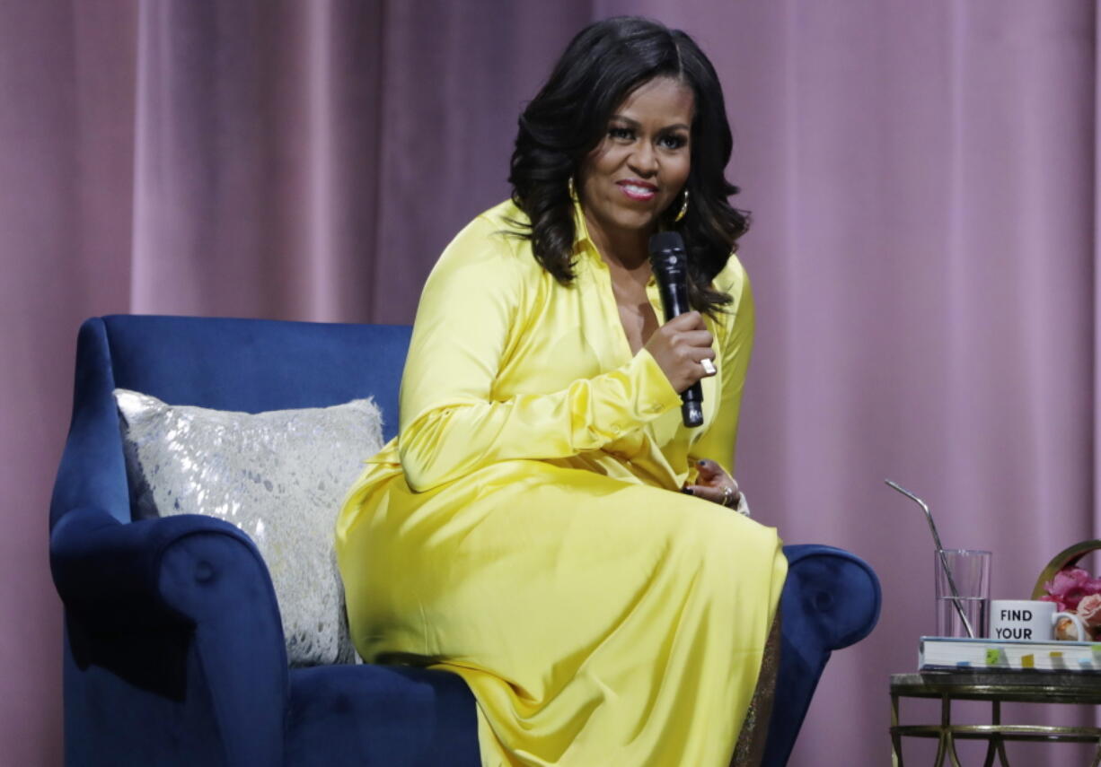 Former first lady Michelle Obama responds to questions as she is interviewed by actress Sarah Jessica Parker during an appearance for her book, “Becoming: An Intimate Conversation with Michelle Obama” at Barclays Center Wednesday, Dec. 19, 2018, in New York.