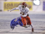 Fresno State wide receiver Derrion Grim (7) is tripped up by Boise State linebacker Tyson Maeva (58) after a reception during the first half of an NCAA college football game for the Mountain West championship Saturday, Dec. 1, 2018, in Boise, Idaho.