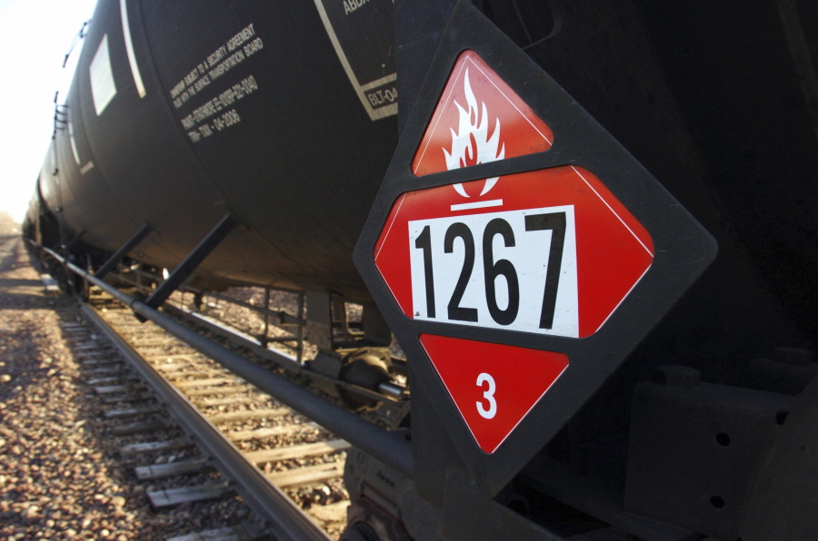 FILE - This Nov. 6, 2013 file photo shows a warning placard on a tank car carrying crude oil near a loading terminal in Trenton, N.D. The Trump administration vastly understated the potential benefits of installing more advanced brakes on trains that haul explosive fuels when it cancelled a requirement for railroads to begin using the equipment. A government analysis used by the administration to justify the cancellation omitted up to $117 million in potential reduced damages from using electronic brakes. Department of Transportation officials acknowledged the error after it was discovered by The Associated Press during a review of federal documents but said it would not have changed their decision.