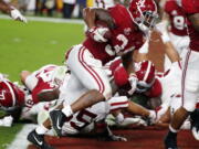 Alabama running back Damien Harris (34) scores a touchdown, during the first half of the Orange Bowl NCAA college football game against Oklahoma, Saturday, Dec. 29, 2018, in Miami Gardens, Fla.