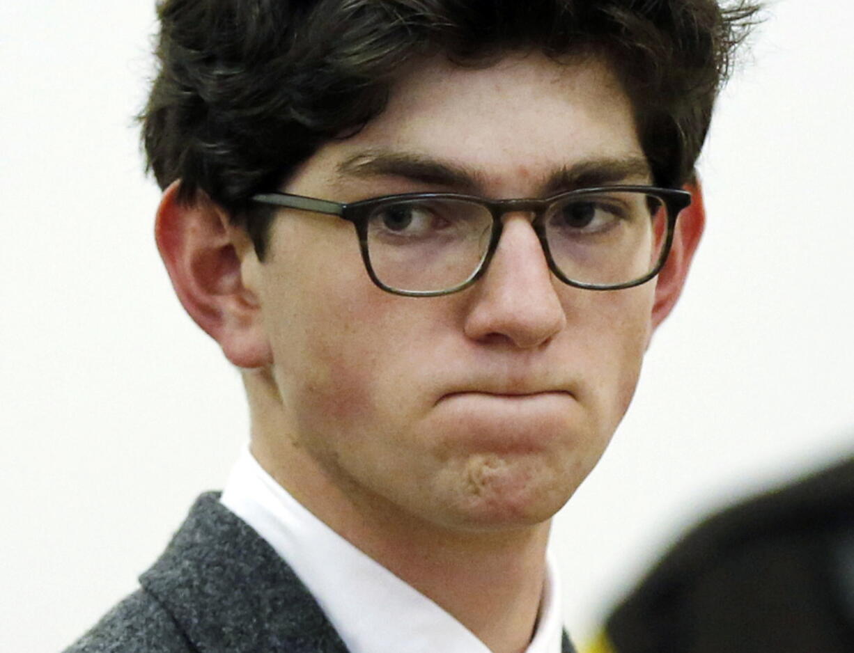 Owen Labrie listens to prosecutors before being sentenced in Merrimack County Superior Court in Concord, N.H. He was convicted of sexually assaulting a younger prep school classmate in 2014 and was sentenced to jail. Labrie reported to the Merrimack County jail on Wednesday, Dec. 26, 2018, to begin serving the remaining 10 months of his jail sentence.