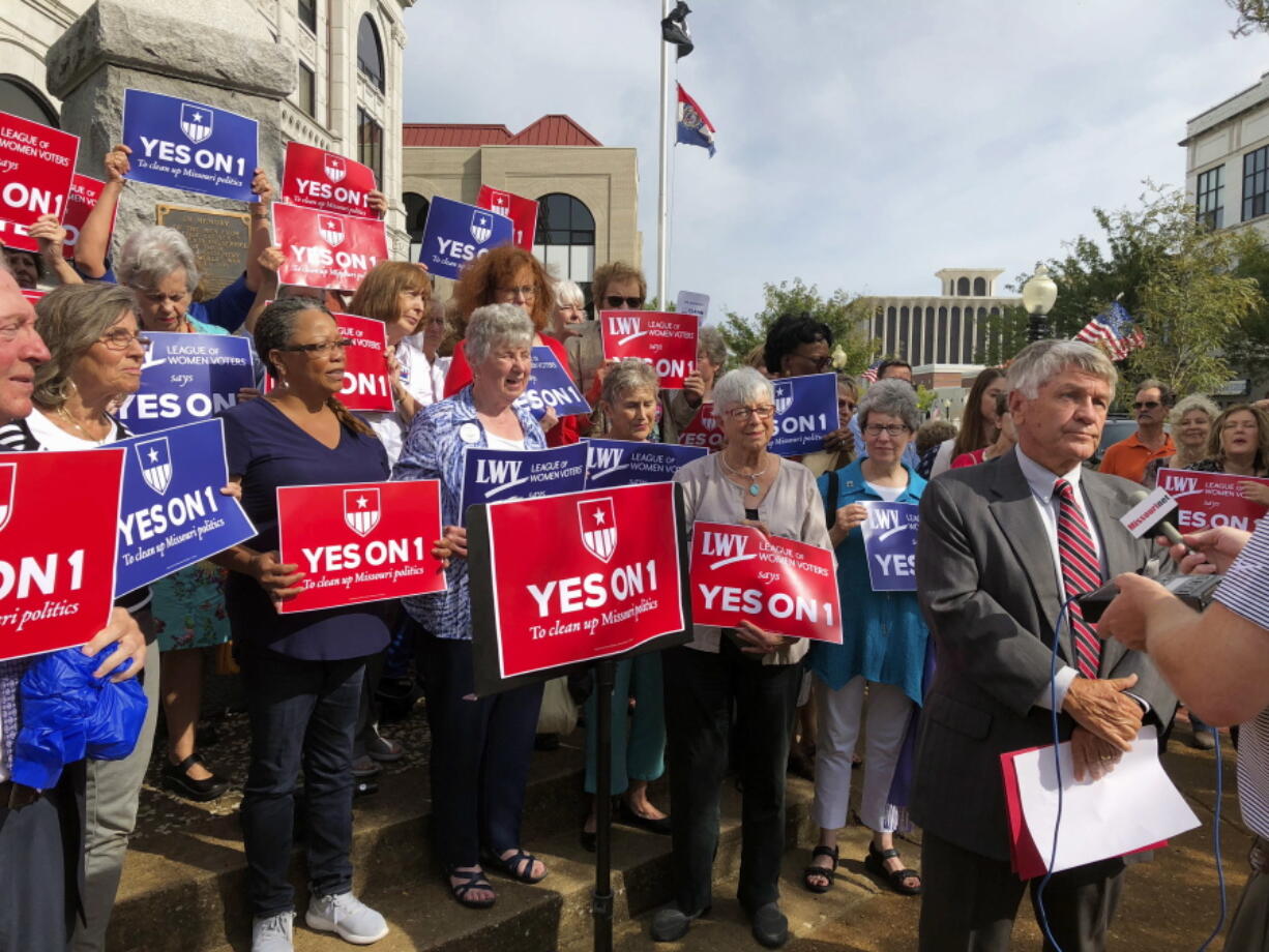 Supporters of Missouri’s redistricting ballot measure hold signs behind former state Sen. Bob Johnson as he serves as their spokesman Aug. 31 during a press conference outside the Cole County Courthouse in Jefferson City, Mo. David A.