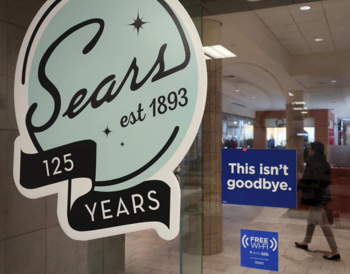 In this Nov. 2, 2018 photo, a sign in the window at Sears promises that “This isn’t goodbye,” at the Livingston Mall in Livingston, N.J. Sears is closing 80 more stores as it teeters on the brink of liquidation. The 130-year old retailer set a deadline of Friday, Dec. 28, 2018 for bids for its remaining stores to avert closing down completely.