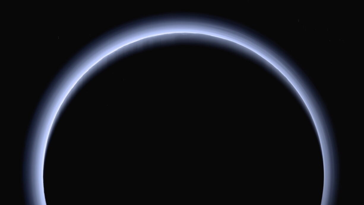 FILE - This image made available by NASA in March 2017 shows Pluto illuminated from behind by the sun as the New Horizons spacecraft travels away from it at a distance of about 120,000 miles (200,000 kilometers). The probe will ring in 2019 by exploring an even more distant and mysterious world.