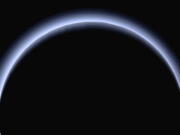 FILE - This image made available by NASA in March 2017 shows Pluto illuminated from behind by the sun as the New Horizons spacecraft travels away from it at a distance of about 120,000 miles (200,000 kilometers). The probe will ring in 2019 by exploring an even more distant and mysterious world.