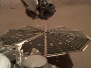 This Friday, Dec. 7, 2018 photo made available by NASA shows a view from the arm-mounted camera on the InSight Mars lander. The spacecraft arrived on the planet on Nov. 26.