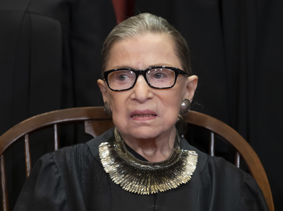 FILE - In this Nov. 30, 2018 file photo, Associate Justice Ruth Bader Ginsburg, nominated by President Bill Clinton, sits with fellow Supreme Court justices for a group portrait at the Supreme Court Building in Washington, Friday. The Supreme Court says Justice Ruth Bader Ginsburg has undergone surgery to remove two malignant growths from her left lung. It is Ginsburg’s third bout with cancer since joining the court in 1993. (AP Photo/J.