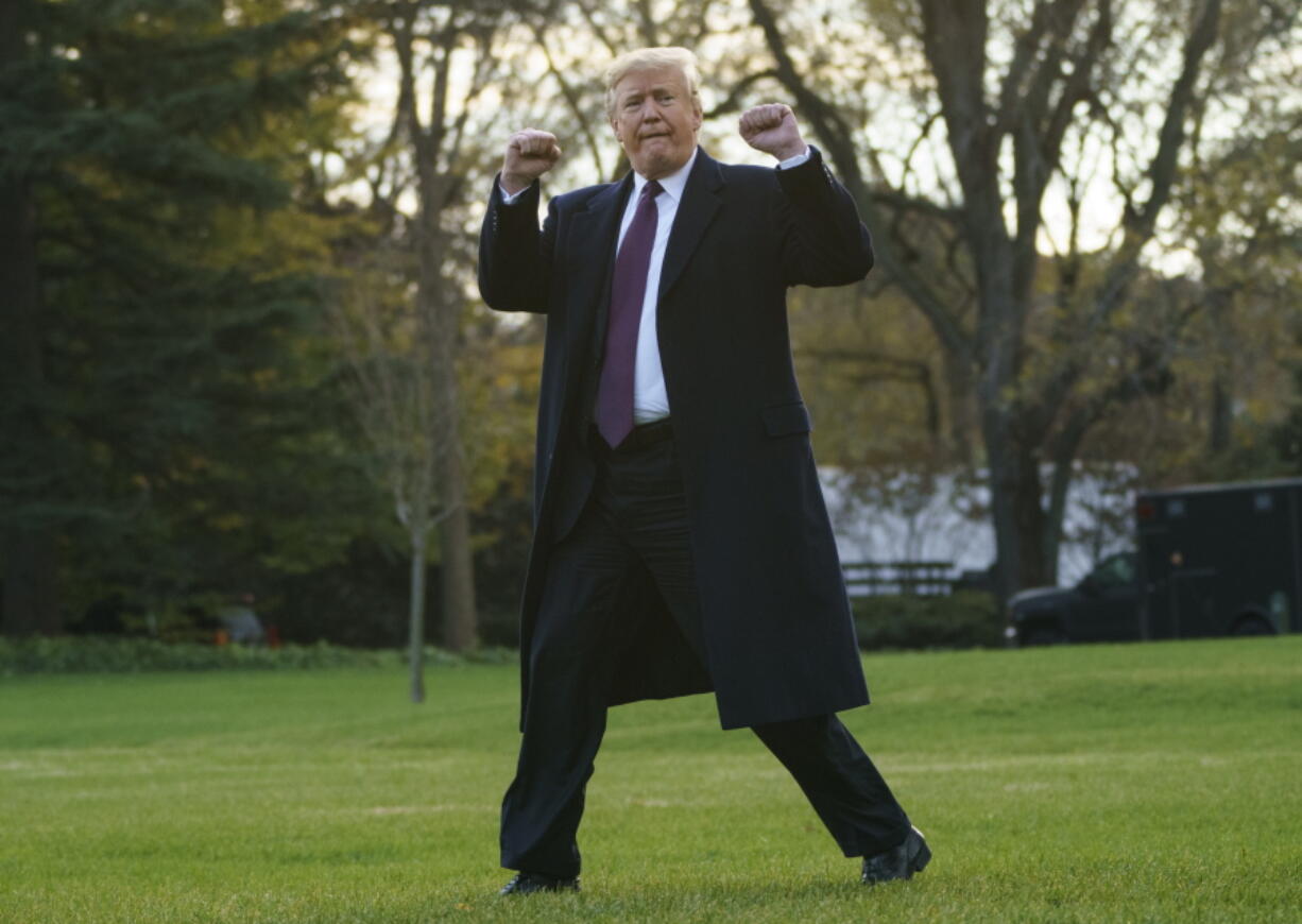 FILE - In this Nov. 20, 2018, file photo, President Donald Trump gestures as he walks to Marine One after speaking to media at the White House in Washington.