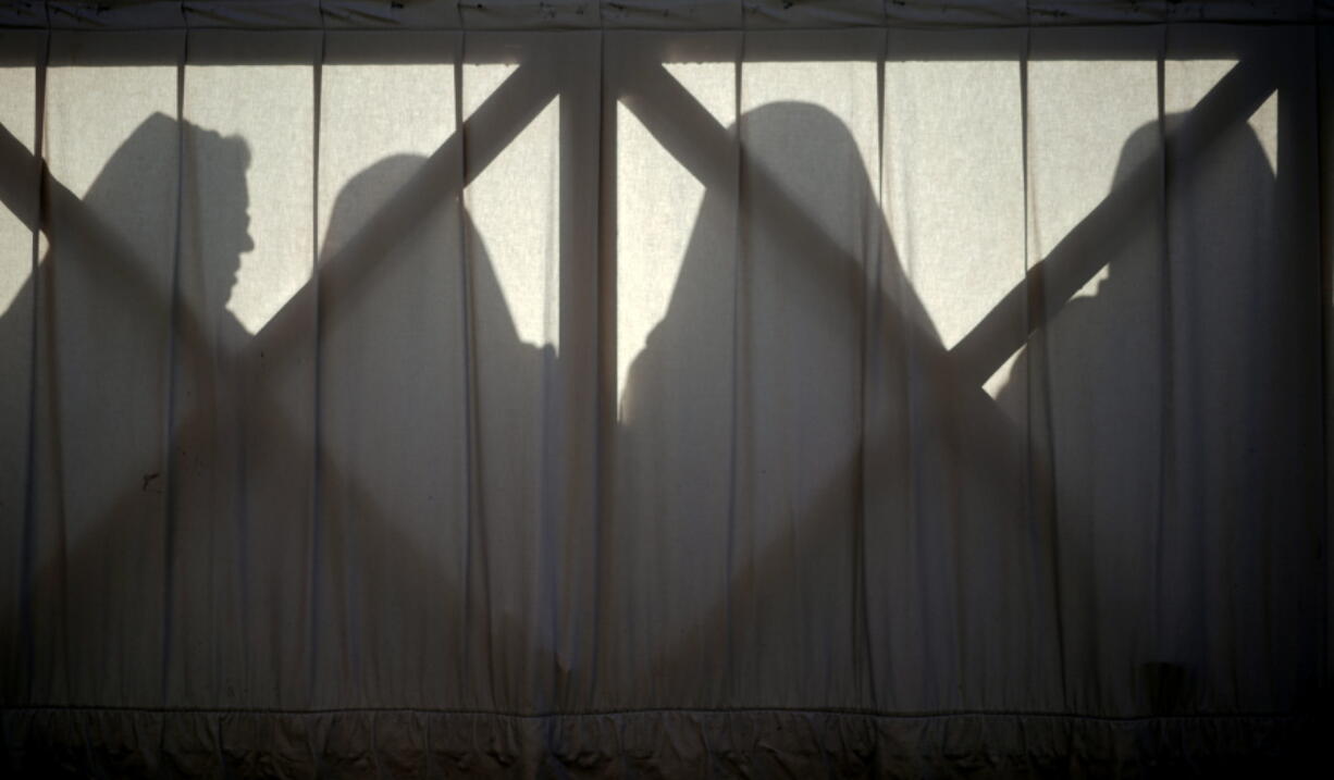 In this Sunday, April 1, 2018 file photo, nuns are silhouetted in St. Peter’s Square at the Vatican. The Vatican is facing a dilemma after nearly all the nuns in a tiny French religious order threatened to renounce their vows rather than accept the removal of their superior. The standoff marks an extraordinary battle of wills between the Vatican and the group of 39 nuns who run homes for the aged in rural France.