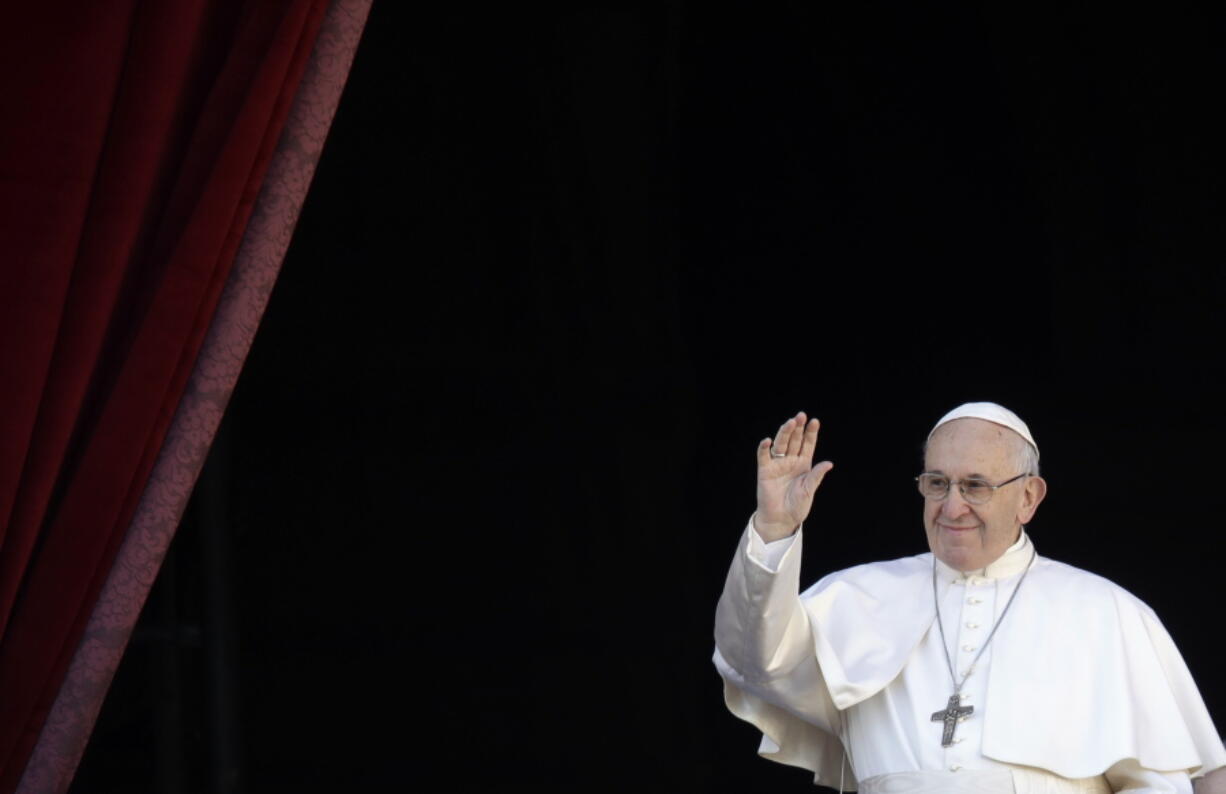 Pope Francis waves as he arrives to deliver the Urbi et Orbi (Latin for ‘to the city and to the world’) Christmas’ day blessing from the main balcony of St. Peter’s Basilica at the Vatican on Tuesday.