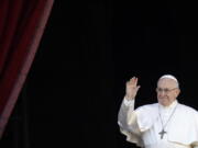 Pope Francis waves as he arrives to deliver the Urbi et Orbi (Latin for ‘to the city and to the world’) Christmas’ day blessing from the main balcony of St. Peter’s Basilica at the Vatican on Tuesday.