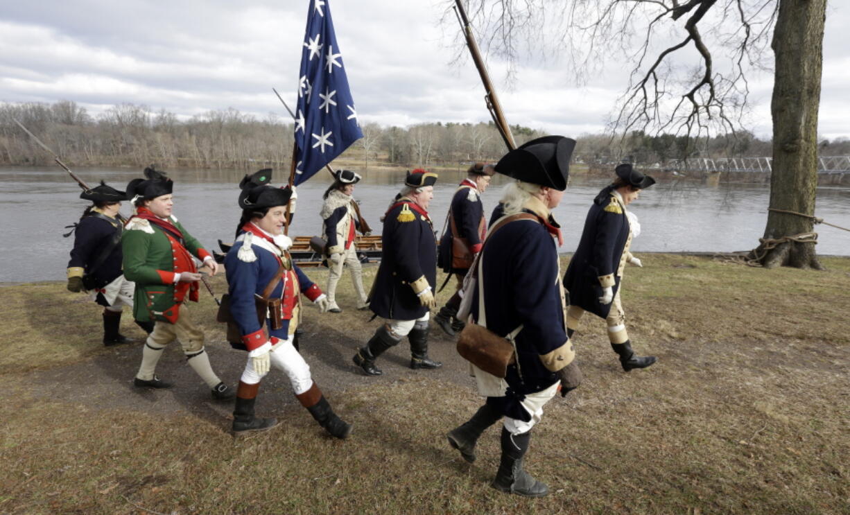 Re-enactor John Godzieba, right, portrays Gen. George Washington as he leads others along the banks of the Delaware River, Tuesday Dec. 25, 2018 in Washington Crossing, Pa. The annual reenactment of George Washington’s daring 1776 crossing of the Delaware River on Christmas Day has once again been left high and dry as organizers announced Monday that the river crossing portion of the reenactment will not take place due to high river conditions following recent rainfall. Other activities carried on as scheduled.