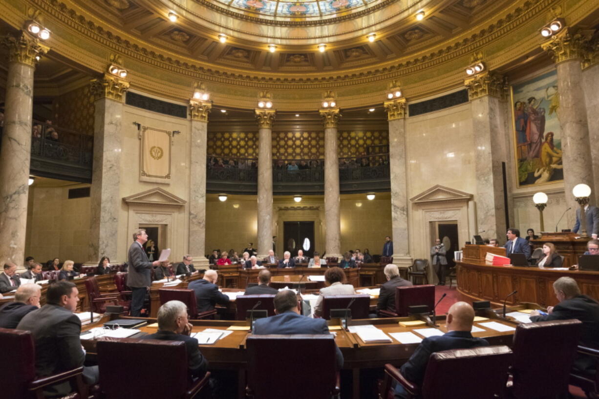 State Sen. Tim Carpenter, left, D-Milwaukee, questions a list of about fifty appointment referrals submitted to the State Senate at the Capitol in Madison, Wis., Tuesday, Dec. 4, 2018. Demonstrators booed outgoing Wisconsin Gov. Scott Walker on Tuesday during the Christmas tree-lighting ceremony, at times drowning out a high school choir with their own songs in protest of a Republican effort to gut the powers of his Democratic successor.