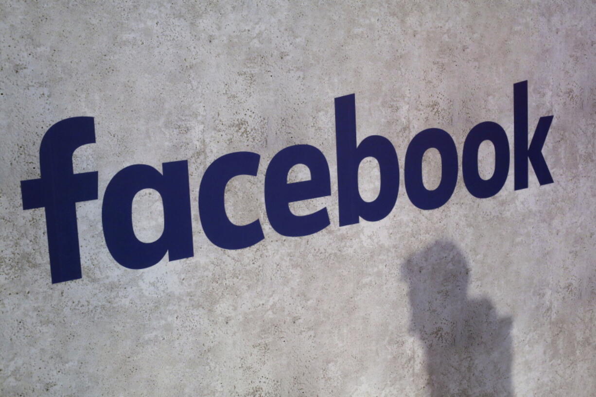 FILE - This Jan. 17, 2017, file photo shows a Facebook logo being displayed in a start-up companies gathering at Paris’ Station F, in Paris. We may remember 2018 as the year in which technology’Äôs dystopian potential became clear, from Facebook’Äôs role enabling the harvesting of our personal data for election interference to a seemingly unending series of revelations about the dark side of Silicon Valley’Äôs connect-everything ethos.