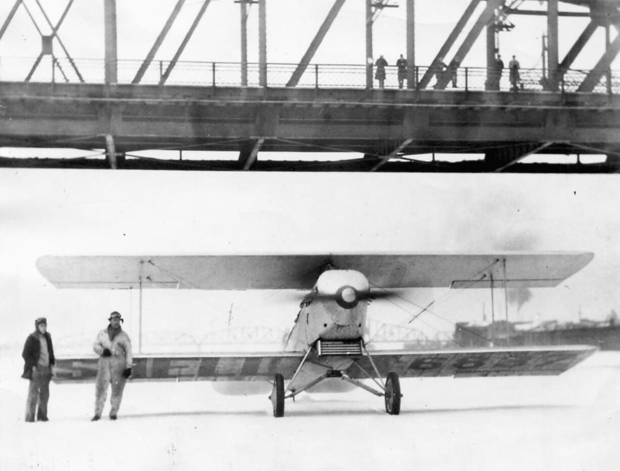 The Columbia River provided a landing strip for the biplane of Glenn Murray, left, and Clarence S. Murray in 1930. The Jan. 31 stunt was made possible by the most consistent cold spell in the region’s recorded history, with 19 consecutive days of daily highs below 32 degrees.