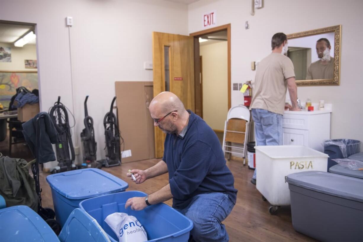 Darren Green collects his insulin from a storage container at St. Paul Lutheran Church, which provides overnight shelter for homeless men during the winter.