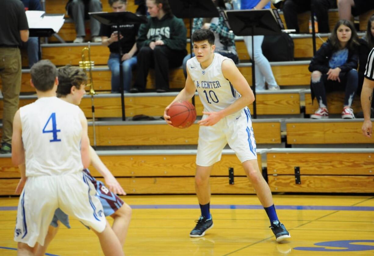 La Center forward Evan Norris gathers the ball during a 103-71 Wildcats win over Stevenson on Thursday night at La Center High School.