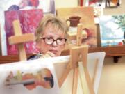 At Cypress Court retirement community in Escondido, Calif., painting class, student Cathie Martin works on a new painting during class in December at the community.