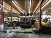 An SUV sits stopped amid what was part of Camas Produce’s fruit selection after its driver, whom the Camas Police Department says was driving while impaired, smashed through the front of the store Thursday evening. No one was injured.