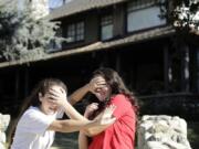 Abby Olague, 15, left, and her sister Bella Olague, 14, of Chino, Calif., improvise their “Bird Box” pose Jan. 4 at the “Bird Box” house in Monrovia, Calif. Myung J.