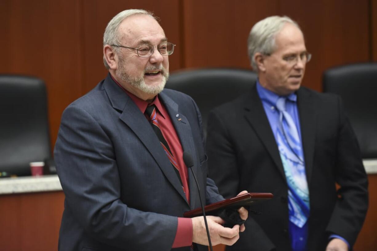 Tom Mielke, from left, accepts a plaque acknowledging his work on the Clark County Council in December 2016 with then-Chair Marc Boldt nearby. Mielke's name is on a list of candidates, released by the local GOP, seeking to complete the term of Republican county Councilor Eileen Quiring, the new council chair.