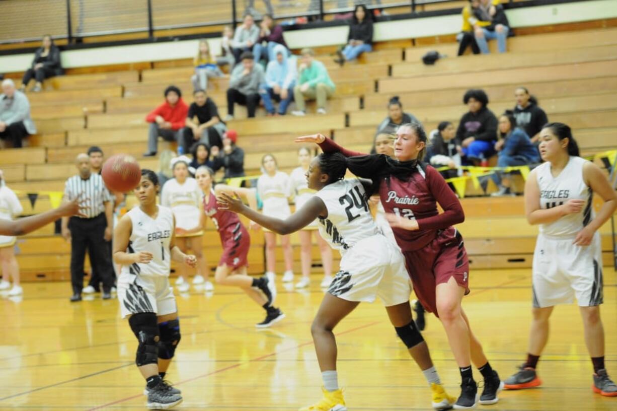 Hudson's Bay's Kamelai Powell (24) defends Prairie's Brooke Walling (12) during a 46-36 Falcon win at Hudson's Bay High School on Tuesday.