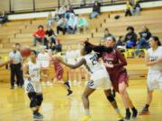 Hudson's Bay's Kamelai Powell (24) defends Prairie's Brooke Walling (12) during a 46-36 Falcon win at Hudson's Bay High School on Tuesday.