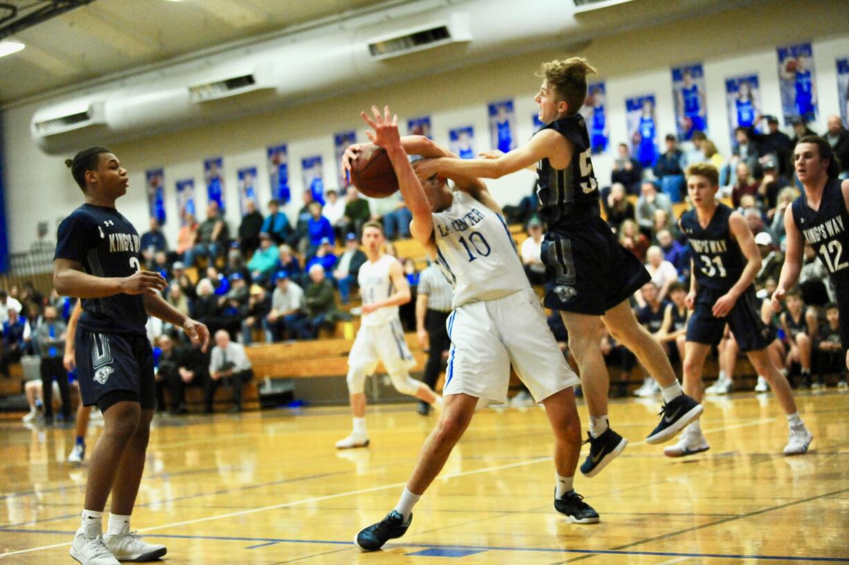 La Center's Evan Norris (10) grabs a rebound from Bryson Metz (right) during a 65-64 King's Way win at La Center High School on Wednesday.