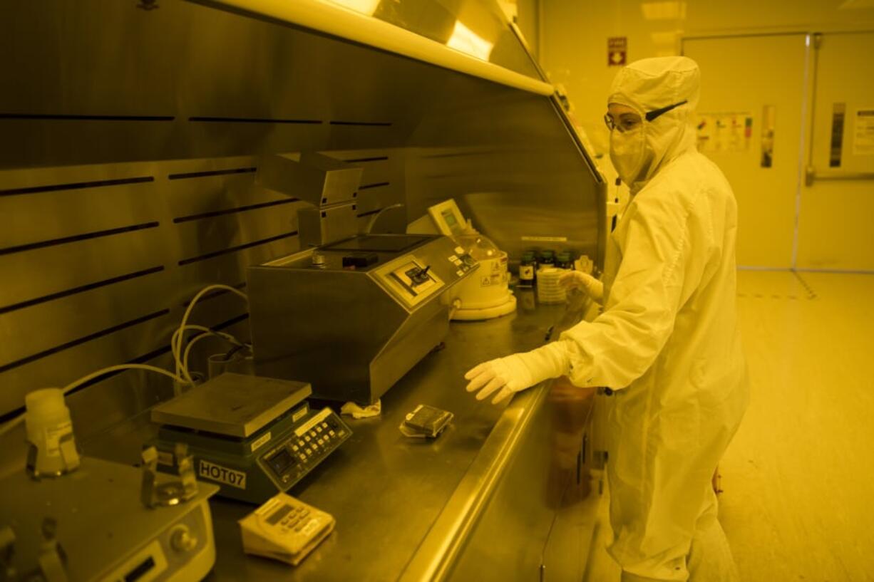 An nLIGHT wafer fab specialist applies photo resistance to wafers during the laser production process at nLIGHT in Vancouver in April.