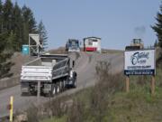 A truck passes a sign for Livingston Mountain Quarry as it enters the facility east of Vancouver on April 26, 2019.