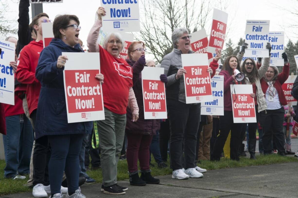 Members of the Vancouver Association of Educational Support Professionals wave signs outside Vancouver Public Schools district offices Thursday, as the union and district continued to negotiate a contract for support staff. The union will strike Friday if a deal is not reached overnight, closing schools for the second time this year due to labor action.