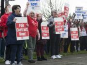 Members of the Vancouver Association of Educational Support Professionals wave signs outside Vancouver Public Schools district offices Thursday, as the union and district continued to negotiate a contract for support staff. The union will strike Friday if a deal is not reached overnight, closing schools for the second time this year due to labor action.